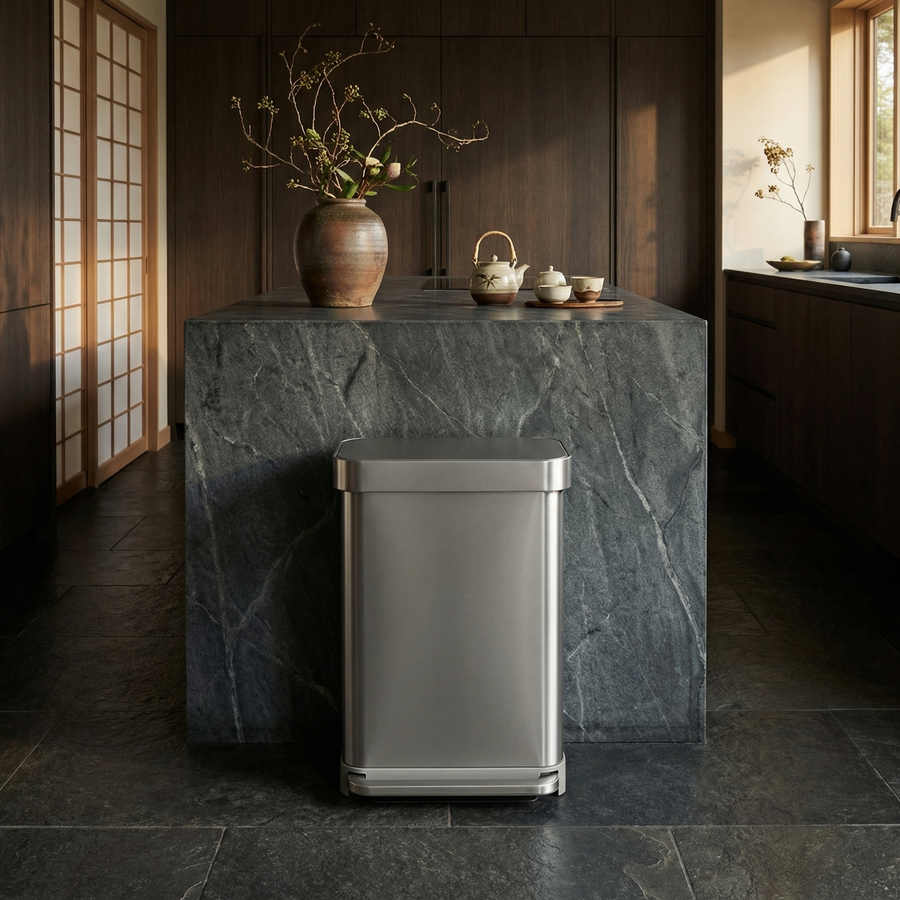 Simplehuman's 45L Step Can in Brushed in an oriental setting with florals, tea pots, marble countertops and flooring, and wooden appliances and sliding door in the background.
