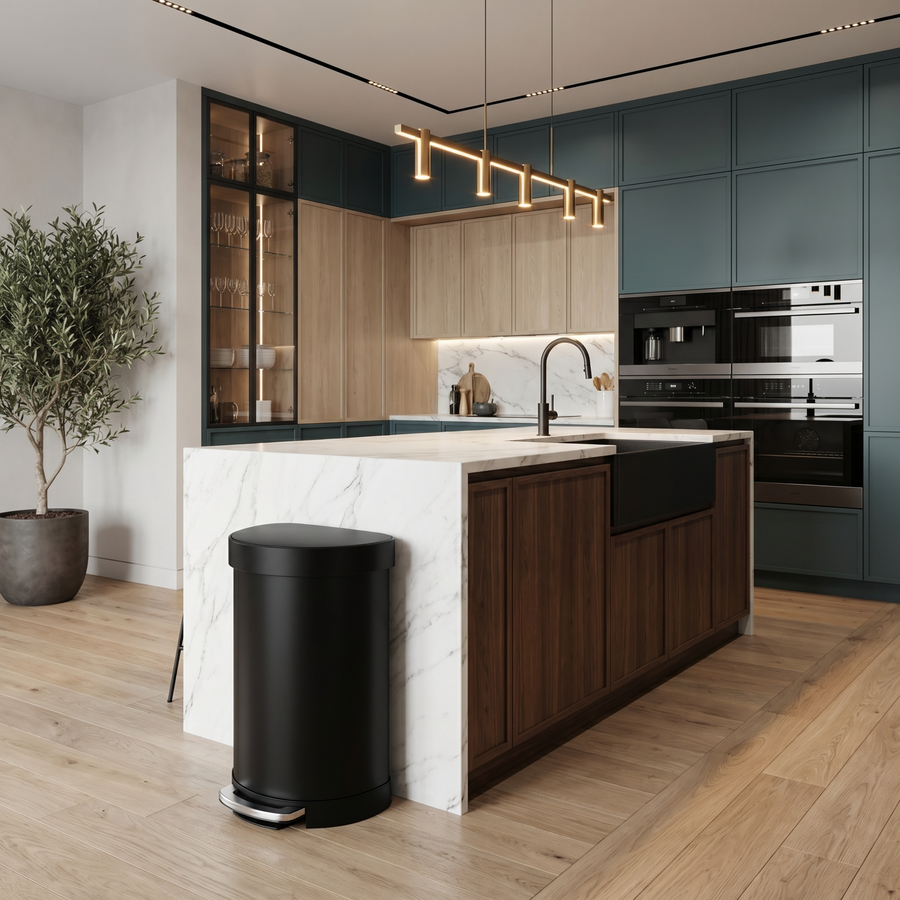 Simplehuman's Semi-Round Step Can in Matte Black in a modern kitchen setting with colorful cabinets and hanging ceiling lights.