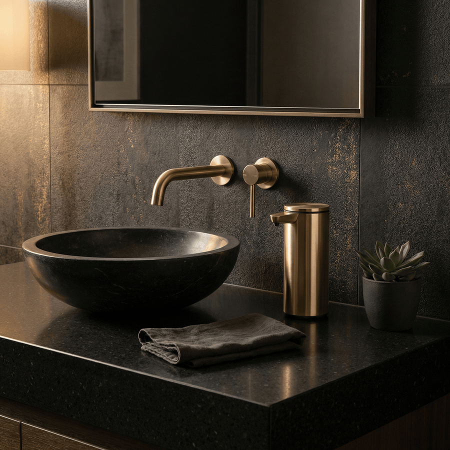 Simplehuman's 9 oz. Liquid Sensor Pump in Brass in a darker bathroom setting with black and gold appliances.