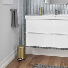 4.5L round pedal bin - brass finish - lifestyle in bathroom next to wall